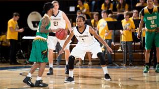 Cedarville University basketball player defending the home court